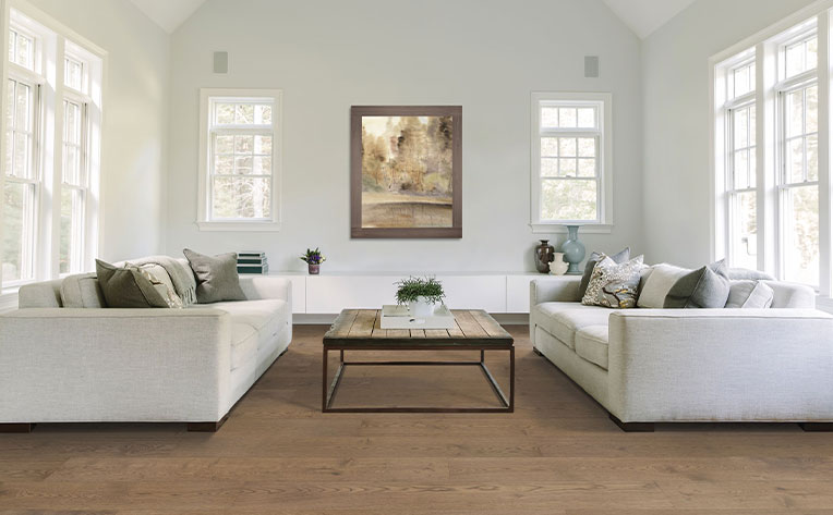 hardwood flooring in living room with two couches